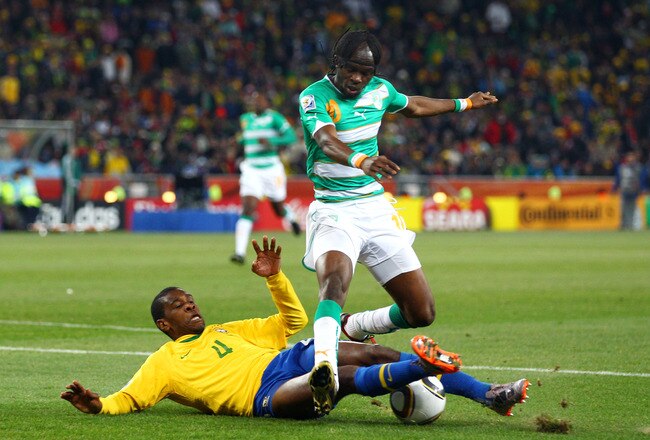 JOHANNESBURG, SOUTH AFRICA - JUNE 20:  Juan of Brazil tackles Gervinho of the Ivory Coast during the 2010 FIFA World Cup South Africa Group G match between Brazil and Ivory Coast at Soccer City Stadium on June 20, 2010 in Johannesburg, South Africa.  (Pho