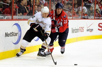 WASHINGTON, DC - DECEMBER 15:  Todd Marchant #22 of the Anaheim Ducks battles for the puck against Scott Hannan #23 of the Washington Capitals at the Verizon Center on December 15, 2010 in Washington, DC.  (Photo by Greg Fiume/Getty Images)