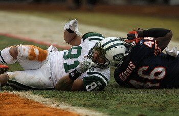 CHICAGO, IL - DECEMBER 26: Dustin Keller #81 of the New York Jets gets grass stuck to his facemask after getting hit by Chris Harris #46 of the Chicago Bears at Soldier Field on December 26, 2010 in Chicago, Illinois. The Bears defeated the Jets 38-34. (P