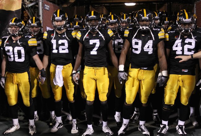 TEMPE, AZ - DECEMBER 28:  (L-R) De'Andre Johnson #30, Ricky Stanzi #12, Marvin McNutt #7, Adrian Clayborn #94 and Jeremiha Hunter #42 of the Iowa Hawkeyes prepare to take the field for the Insight Bowl against the Missouri Tigers at Sun Devil Stadium on D