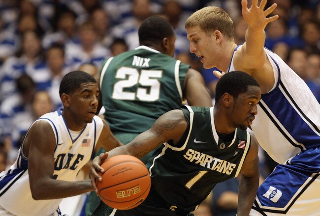 DURHAM, NC - DECEMBER 01:  Kalin Lucas #1 of the Michigan State Spartans tries to dribble out of a trap by Kyrie Irving #1 and Mason Plumlee #5 of the Duke Blue Devils during their game at Cameron Indoor Stadium on December 1, 2010 in Durham, North Caroli