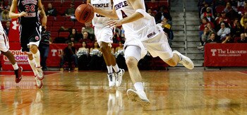 PHILADELPHIA, PA - DECEMBER 18:  Juan Fernandez #4 of the Temple Owls drives against the Northern Illinois Huskies at the Liacouras Center on December 18, 2010 in Philadelphia, Pennsylvania.  (Photo by Chris Chambers/Getty Images)