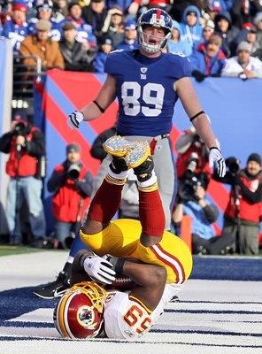 EAST RUTHERFORD, NJ - DECEMBER 05:  London Fletcher #59 of the Washington Redskins intercepts a pass in the endzone intended for Kevin Boss #89 of the New York Giants on December 5, 2010 at the New Meadowlands Stadium in East Rutherford, New Jersey.  (Pho