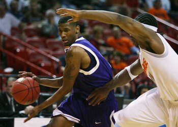 MIAMI - MARCH 20:  Guard Walt Harris #4 (L) of the  Stephen F. Austin Lumberjacks drives past  forward Paul Harris #11 of the Syracuse Orange during the first round of the NCAA Division I Men's Basketball Tournament at the American Airlines Arena on March