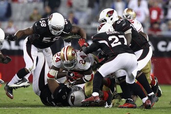 GLENDALE, AZ - NOVEMBER 29:  Runningback Anthony Dixon #24 of the San Francisco 49ers is tackled after rushing the football against the Arizona Cardinals during the NFL game at the University of Phoenix Stadium on November 29, 2010 in Glendale, Arizona.