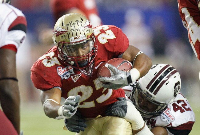 ATLANTA, GA - DECEMBER 31:  Chris Thompson #23 of the Florida State Seminoles is tackled by Travian Robertson #42 of the South Carolina Gamecocks during the 2010 Chick-fil-A Bowl at Georgia Dome on December 31, 2010 in Atlanta, Georgia.  (Photo by Kevin C