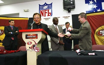 SAN FRANCISCO - SEPTEMBER 28:  Noel Lee (2nd-L), founder of Monster Cable Company, presents gifts at a press conference announcing the naming rights of the San Francisco 49ers stadium to 'Monster Park' on September 28, 2004 at Monster Park in San Francisc
