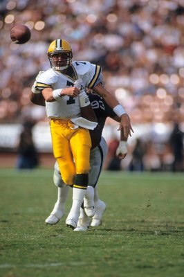 LOS ANGELES, CA - NOVEMBER 11:  Quarterback Don Majkowski #7 of the Green Bay Packers gets off a pass before being hit by defensive end Greg Townsend #93 of the Los Angeles Raiders during a game at the Los Angeles Memorial Coliseum on November 11, 1990 in