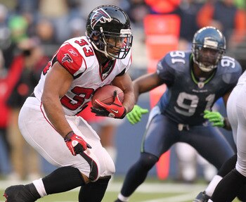 SEATTLE, WA - DECEMBER 19:  Running back Michael Turner #33 of the Atlanta Falcons rushes against the Seattle Seahawks at Qwest Field on December 19, 2010 in Seattle, Washington. (Photo by Otto Greule Jr/Getty Images)