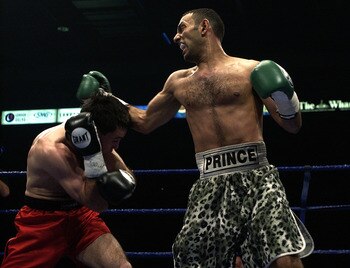 LONDON - May 18:  Prince Naseem Hamed (R) wins the IBO world featherweight title against Manuel Calvo at the London Arena in England on May 18, 2002. DIGITAL IMAGE (Photo by John Gichigi/Getty Images)