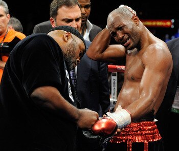 LAS VEGAS - APRIL 03:  Bernard Hopkins (R) holds his head as his trainer Naazim Richardson takes his gloves off after Hopkins defeated Roy Jones Jr. in their light heavyweight bout by unanimous decision at the Mandalay Bay Events Center April 3, 2010 in L