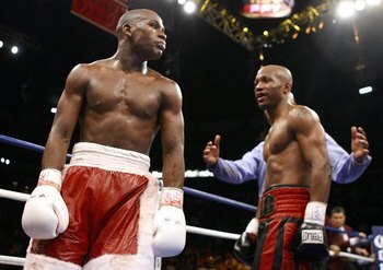 LAS VEGAS - APRIL 08:  (L-R)  Floyd Mayweather walks away at the end of the fight against Zab Judah with a right during the Welterweight Championship fight at Thomas & Mack Arena on April 8, 2006 in Las Vegas, Nevada. Mayweather was named winner against J