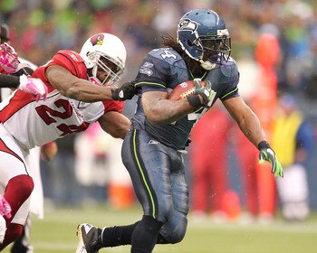 SEATTLE - OCTOBER 24:  Running back Marshawn Lynch #24 of the Seattle Seahawks rushes against Adrian Wilson #24 of the Arizona Cardinals at Qwest Field on October 24, 2010 in Seattle, Washington. The Seahawks defeated the Cardinals 22-10. (Photo by Otto G