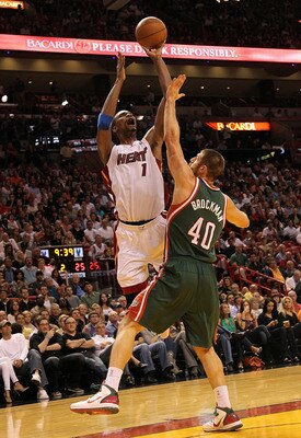 MIAMI, FL - JANUARY 04: Chris Bosh #1 of the Miami Heat shoots over Jon Brockman of the Milwaukee Bucks during a game at American Airlines Arena on January 4, 2011 in Miami, Florida. NOTE TO USER: User expressly acknowledges and agrees that, by downloadin