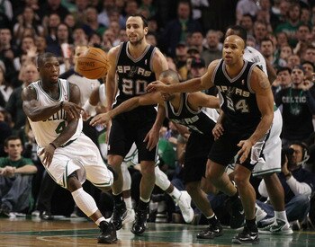 BOSTON, MA - JANUARY 05:  Nate Robinson #4 of the Boston Celtics avoids getting fouled by Tony Parker #9,Manu Ginobili #20 and Richard Jefferson #24 of the San Antonio Spurs on January 5, 2011 at the TD Garden in Boston, Massachusetts. The Celtics defeate