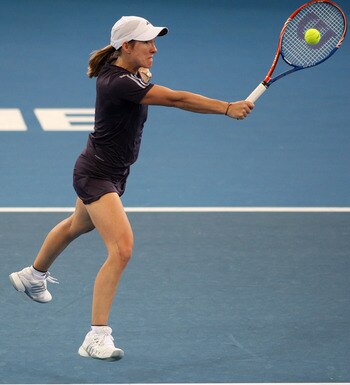 BRISBANE, AUSTRALIA - JANUARY 04:  Justine Henin of Belgium plays a backhand volley in her first round match against Nadia Petrova of Russiaduring day two of the Brisbane International 2010 at Queensland Tennis Centre on January 4, 2010 in Brisbane, Austr