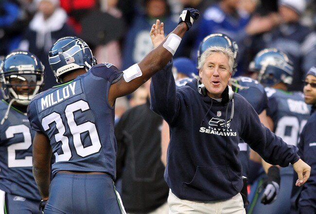 SEATTLE, WA - JANUARY 08:  Head coach Pete Carroll and Lawyer Milloy #36 of the Seattle Seahawks celebrate a fourth down stop by the Seahawks in the third quarter against the New Orleans Saints during the 2011 NFC wild-card playoff game at Qwest Field on