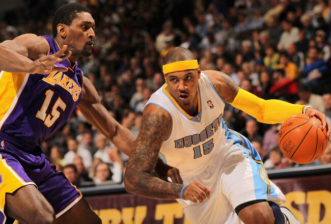 DENVER - NOVEMBER 11:  Carmelo Anthony #15 of the Denver Nuggets drives past Ron Artest #15 of the Los Angeles Lakers at Pepsi Center on November 11, 2010 in Denver, Colorado. The Nuggets defeated the Lakers 118-112.  NOTE TO USER: User expressly acknowle