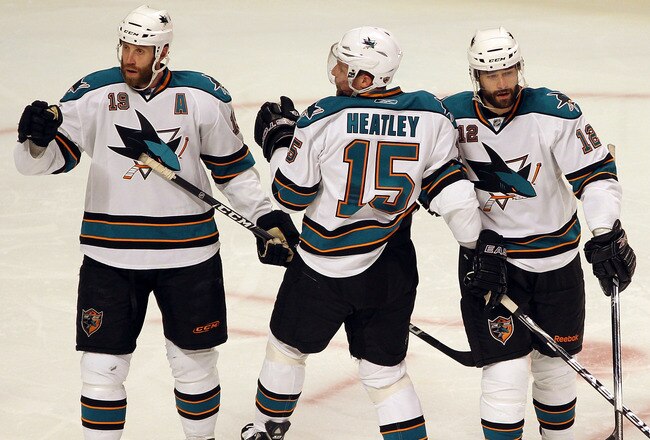 CHICAGO - MAY 21:  (L-R) Joe Thornton #19, Dany Heatley #15, Patrick Marleau #12 and Dan Boyle #12 of the San Jose Sharks react after the second period goal by Marleau while taking on the Chicago Blackhawks in Game Three of the Western Conference Finals d