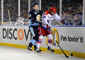 PITTSBURGH, PA - JANUARY 01:  Nicklas Backstrom #19 of the Washington Capitals battles for the puck against Mark Letestu #10 of the Pittsburgh Penguins during the 2011 NHL Bridgestone Winter Classic at Heinz Field on January 1, 2011 in Pittsburgh, Pennsyl