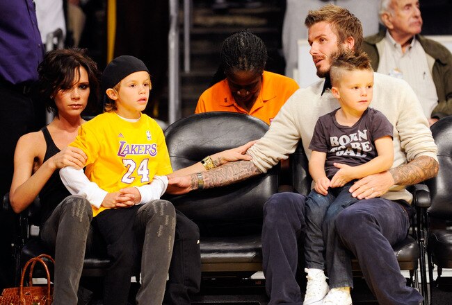 LOS ANGELES, CA - OCTOBER 30:  David Beckham and his wife Victoria follow the action between the Los Angeles Lakers and  the Dallas Mavericks along with their children Cruz (R) and Romeo (L) at Staples Center on October 30, 2009 in Los Angeles, California