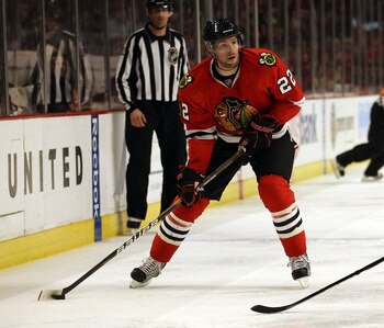 CHICAGO, IL - DECEMBER 17: Troy Brouwer #22 of the Chicago Blackhawks looks to pass against the Detroit Red Wings at the United Center on December 17, 2010 in Chicago, Illinois. The Blackhawks defeated the Red Wings 4-1. (Photo by Jonathan Daniel/Getty Im