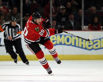 CHICAGO, IL - DECEMBER 17: Jack Skille #20 of the Chicago Blackhawks passes the puck against the Detroit Red Wings at the United Center on December 17, 2010 in Chicago, Illinois. The Blackhawks defeated the Red Wings 4-1. (Photo by Jonathan Daniel/Getty I