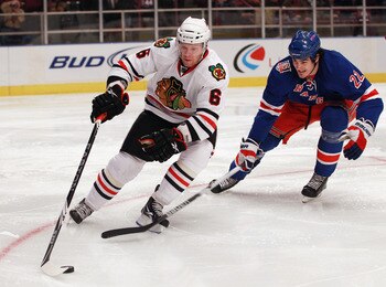 NEW YORK - NOVEMBER 01:  Jordan Hendry #6 of the Chicago Blackhawks skates against the New York Rangers battle for the puck at Madison Square Garden on November 1, 2010 in New York City.  (Photo by Bruce Bennett/Getty Images)