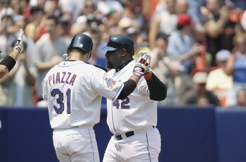FLUSHING, NY - AUGUST 4:  First baseman Mo Vaughn #42 of the New York Mets receives congratulations from catcher Mike Piazza #31 after hitting a two-run home run during the MLB game against the Arizona Diamondbacks on August 4, 2002 at Shea Stadium in Flu