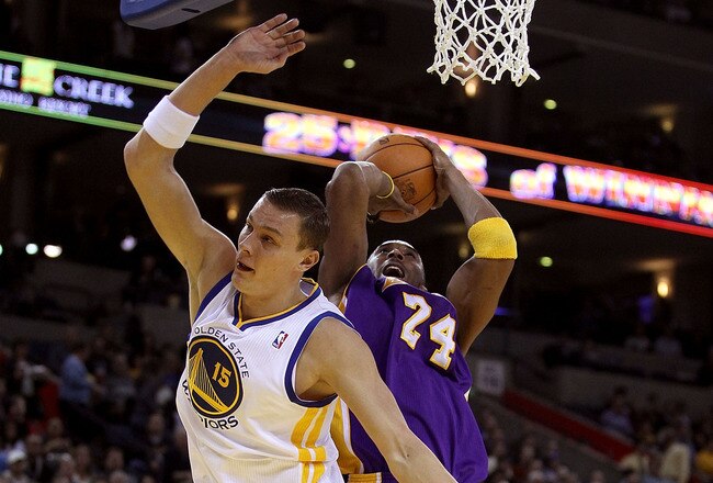 OAKLAND, CA - JANUARY 12: Kobe Bryant #24 of the Los Angeles Lakers is fouled by Andris Biedrins #15 of the Golden State Warriors at Oracle Arena on January 12, 2011 in Oakland, California. NOTE TO USER: User expressly acknowledges and agrees that, by dow