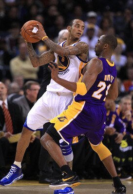 OAKLAND, CA - JANUARY 12: Kobe Bryant #24 of the Los Angeles Lakers plays tight defense on Monta Ellis #8 of the Golden State Warriors at Oracle Arena on January 12, 2011 in Oakland, California. NOTE TO USER: User expressly acknowledges and agrees that, b