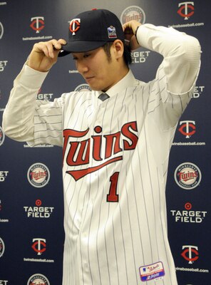 MINNEAPOLIS, MN - DECEMBER 18: Tsuyoshi Nishioka #1 of the Minnesota Twins puts on his Twins hats for members of the media during a press conference on December 18, 2010 at Target Field in Minneapolis, Minnesota. (Photo by Hannah Foslien /Getty Images)
