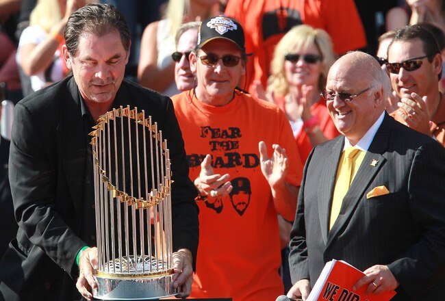 SAN FRANCISCO - NOVEMBER 03:  San Francisco Giants manager Bruce Bochy (L) carries the World Series trophy at the conclusion of the Giants' victory parade on November 3, 2010 in San Francisco, California. Thousands of Giants fans lined the streets of San