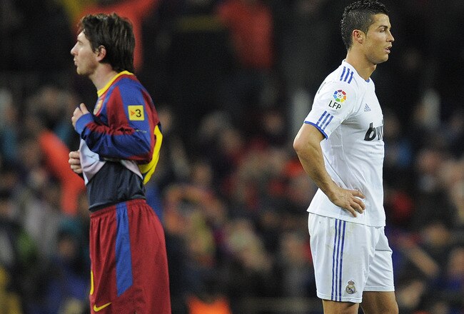 BARCELONA, SPAIN - NOVEMBER 29:  Cristiano Ronaldo of Real Madrid (R) and Lionel Messi of FC Barcelona look on during the La Liga match between Barcelona and Real Madrid at the Camp Nou Stadium on November 29, 2010 in Barcelona, Spain.  Barcelona won the