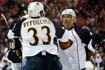 MONTREAL, CANADA - JANUARY 2:  Dustin Byfuglien #33 of the Atlanta Thrashers celebrates his overtime goal with team mates during the NHL game against the Montreal Canadiens at the Bell Centre on January 2, 2011 in Montreal, Quebec, Canada.  The Thrashers
