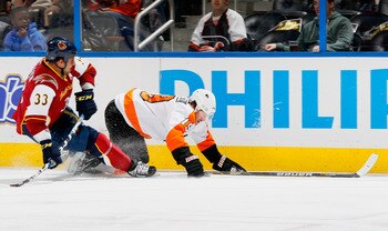 ATLANTA, GA - JANUARY 14:  Scott Hartnell #19 of the Philadelphia Flyers falls to the ice in front of Dustin Byfuglien #33 of the Atlanta Thrashers at Philips Arena on January 14, 2011 in Atlanta, Georgia.  (Photo by Kevin C. Cox/Getty Images)