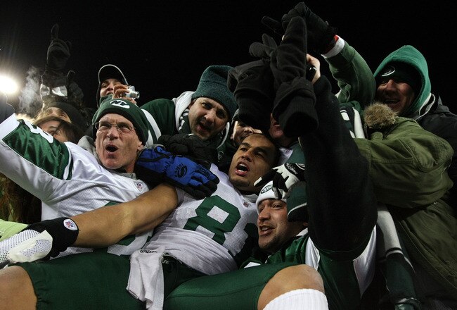 FOXBORO, MA - JANUARY 16:  Dustin Keller #81 of the New York Jets celebrates with fans after the Jets defeated the Patriots 28 to 21 in their 2011 AFC divisional playoff game at Gillette Stadium on January 16, 2011 in Foxboro, Massachusetts.  (Photo by Al