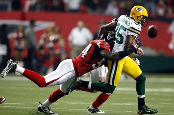 ATLANTA, GA - JANUARY 15:  Greg Jennings #85 of Green Bay Packers fumbles the ball in the first quarter against Stephen Nicholas #54 of the Atlanta Falcons during their 2011 NFC divisional playoff game at Georgia Dome on January 15, 2011 in Atlanta, Georg