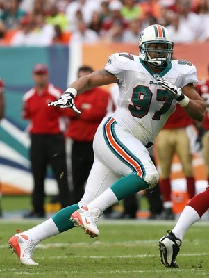 MIAMI - DECEMBER 14:  Defensive end Phillip Merling #97 of the Miami Dolphins chases quarterback Shaun Hill #13 of the San Francisco 49ers at Dolphin Stadium on December 14, 2008 in Miami, Florida. The Dolphins defeated the 49ers 14-9.  (Photo by Doug Ben