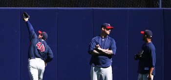 NEW YORK - OCTOBER 08: (L-R) Carl Pavano #48 of the Minnesota Twins fields a ball while Jon Rauch #60 and Francisco Liriano #47 talk during warm ups prior to game three, to take place on October 9, of the America League Division Series against the New Yor