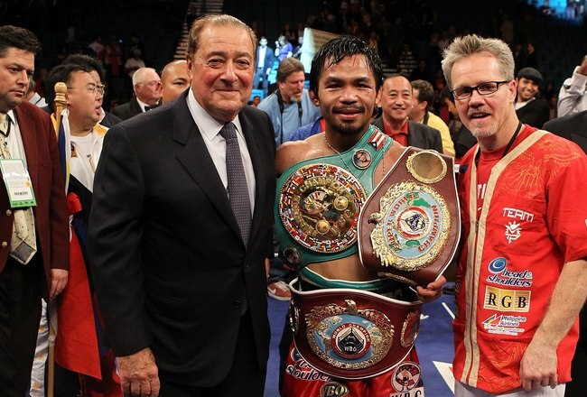 LAS VEGAS - NOVEMBER 14:  (L-R) Promoter Bob Arum, boxer Manny Pacquiao and trainer Freddie Roach celebrate Pacquiao's 12 round TKO victory against Miguel Cotto during their WBO welterweight title fight at the MGM Grand Garden Arena on November 14, 2009 i