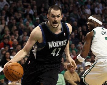 BOSTON, MA - JANUARY 03:  Kevin Love #42 of the Minnesota Timberwolves drives around Jermaine O'Neal #7 of the Boston Celtics on January 3, 2011 at the TD Garden in Boston, Massachusetts. The Celtics defeated the Timberwolves 96-93. NOTE TO USER: User exp