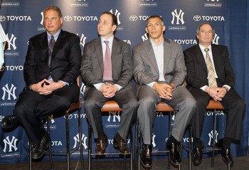 NEW YORK, NY - JANUARY 19:  (L-R) President Randy Levine, general manager Brian Cashman, manager Joe Girardi and COO Lonn Trost of the New York Yankees listen as Rafael Soriano (not pictured) speaks during his introduction press conference on January 19,
