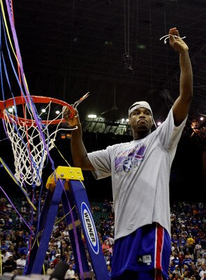 SAN ANTONIO - APRIL 07:  Darnell Jackson #32 of the Kansas Jayhawks celebrates by cutting down the nets after defeating the Memphis Tigers 75-68 in overtime during the 2008 NCAA Men's National Championship game at the Alamodome on April 7, 2008 in San Ant