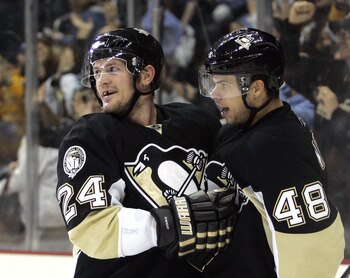 PITTSBURGH, PA - JANUARY 18:  Matt Cooke #24 of the Pittsburgh Penguins celebrates his empty net goal with Tyler Kennedy #48 against the Detroit Red Wings at Consol Energy Center on January 18, 2011 in Pittsburgh, Pennsylvania.  The Penguins defeated the 