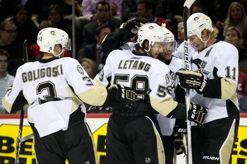 MONTREAL, CANADA - JANUARY 12:  Chris Kunitz #14 of the Pittsburgh Penguins celebrates his third period goal with team mates (L-R) Alex Goligoski #3, Kris Letang #58 and Jordan Staal #11 during the NHL game against the Montreal Canadiens at the Bell Centr