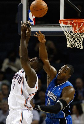 CHARLOTTE, NC - NOVEMBER 10:  Dwight Howard #12 of the Orlando Magic knocks the ball away from Nazr Mohammed #13 of the Charlotte Bobcats during their game at Time Warner Cable Arena on November 10, 2009 in Charlotte, North Carolina.  (Photo by Streeter L