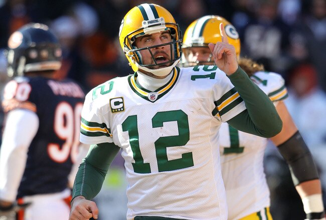 CHICAGO, IL - JANUARY 23:  Quarterback Aaron Rodgers #12 of the Green Bay Packers reacts after he scores a one-yard touchdown against the Chicago Bears in the first quarter of the NFC Championship Game at Soldier Field on January 23, 2011 in Chicago, Illi