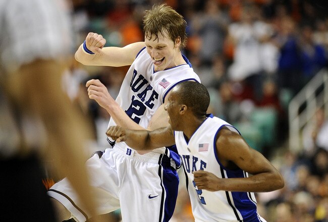 GREENSBORO, NC - MARCH 12:  Kyle Singler #12 and Nolan Smith #2 of the Duke Blue Devils celebrate during win over the University of Virginia Cavaliers in their quarterfinal game in the 2010 ACC Men's Basketball Tournament at the Greensboro Coliseum on Mar