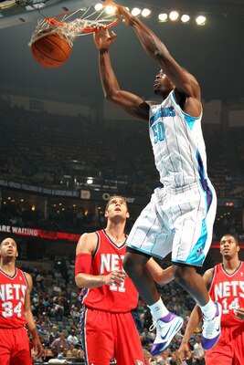 NEW ORLEANS, LA - DECEMBER 22:  Emeka Okafor #50 of the New Orleans Hornets dunks the ball over Brook Lopez #11 of the New Jersey Nets at the New Orleans Arena on December 22, 2010 in New Orleans, Louisiana.   NOTE TO USER: User expressly acknowledges and